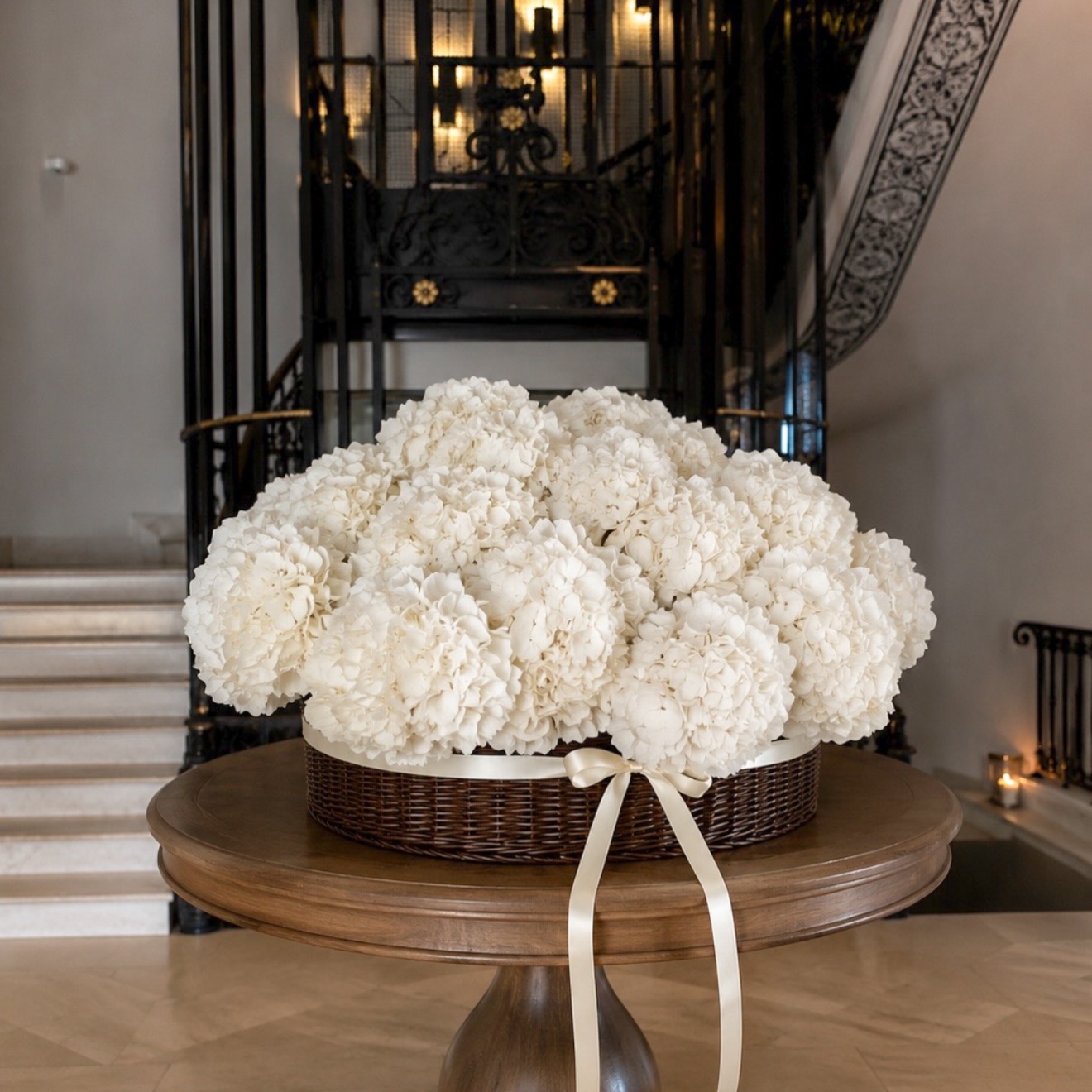 White hydrangeas in a ribbon-tied basket